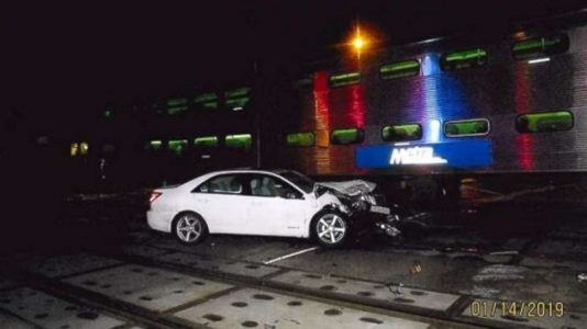 Bystanders, police rescue woman stuck on tracks just before train crashes into car