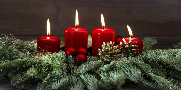 advent decoration with four red burning candles