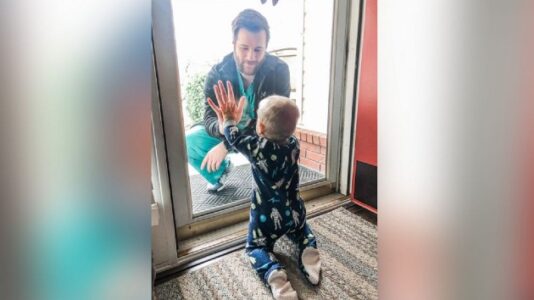 Doctor in viral photo greeting son though glass door narrowly escapes tornado