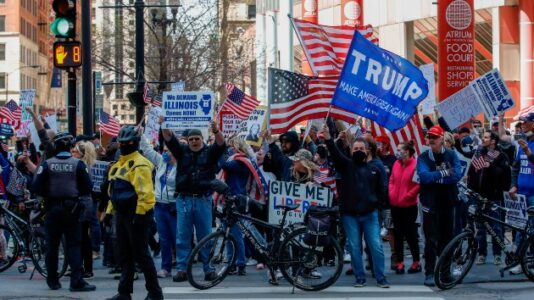 Nazi slogan sign displayed at ‘re-open Illinois’ rally ripped by Auschwitz Memorial