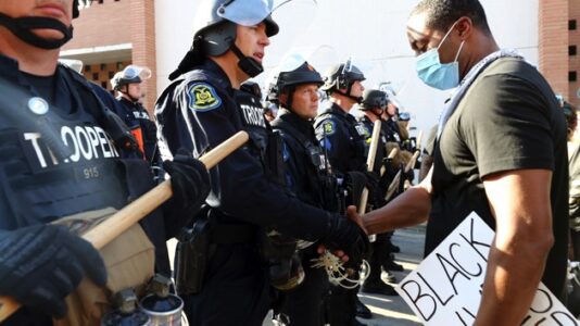 Why some police officers stood with protesters outraged over George Floyd’s death