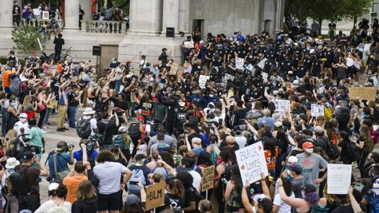 Black police officers straddle both sides during protests