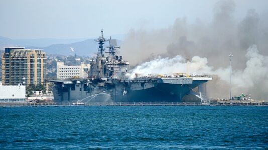 Work continues to contain fire on Navy ship thought extinguished overnight