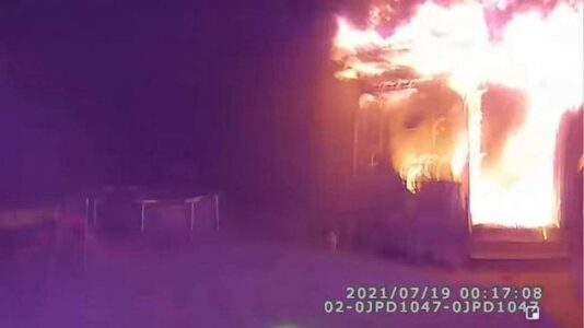 Incredible body camera footage shows hero cop catch people jumping from building engulfed in flames