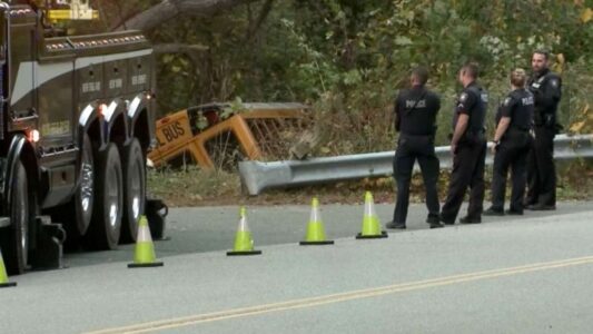 School bus carrying 6 children crashes into woods after driver suffers medical emergency