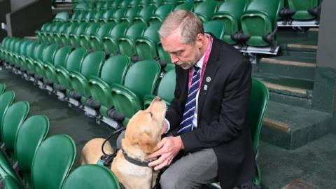 Flo and owner Mark Millsand together in the stands on Centre Court at Wimbledon. Via ABC News