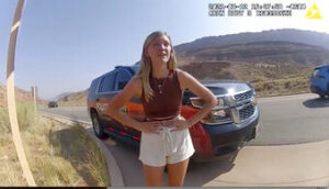 This police camera video provided by The Moab Police Department shows Gabrielle “Gabby” Petito talking to a police officer after police pulled over the van she was traveling in with her boyfriend, Brian Laundrie, near the entrance to Arches National Park on Aug. 12, 2021. The couple was pulled over while they were having an emotional fight. Petito was reported missing by her family a month later and is now the subject of a nationwide search. (The Moab Police Department via AP)