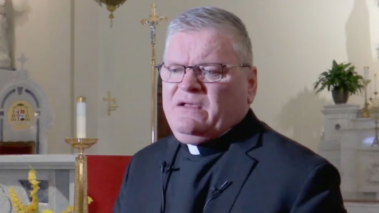 Security camera captures man attacking priest during church service